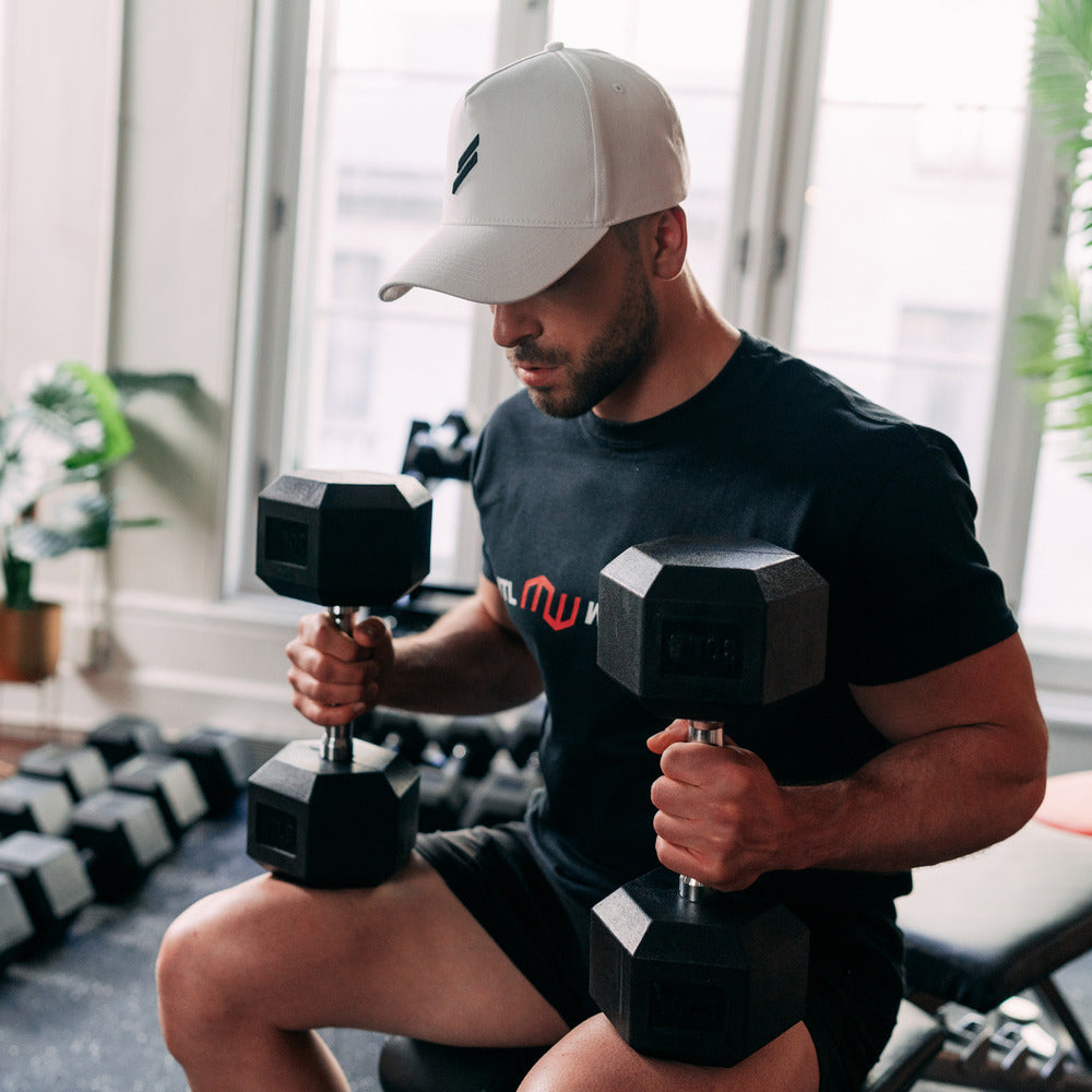 Man sitting and holding dumbbells