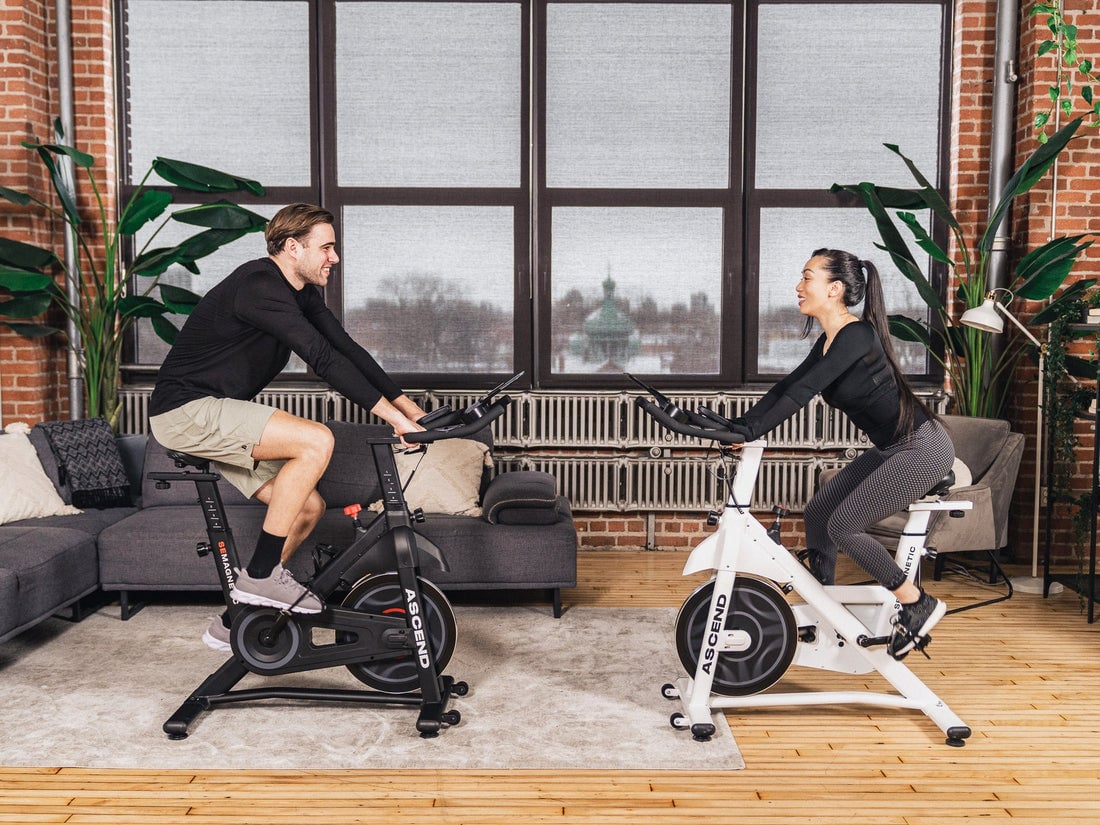 Couple working out together on stationary bikes