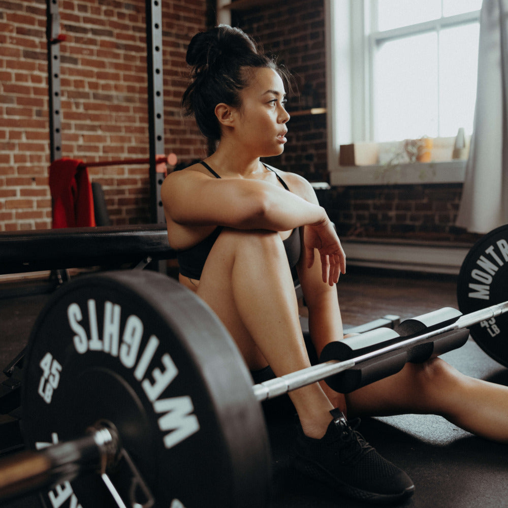 woman sitting down in home gym